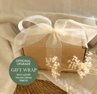 a gift wrap with a white ribbon on it