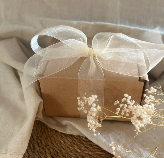 a wrapped present box with a white ribbon