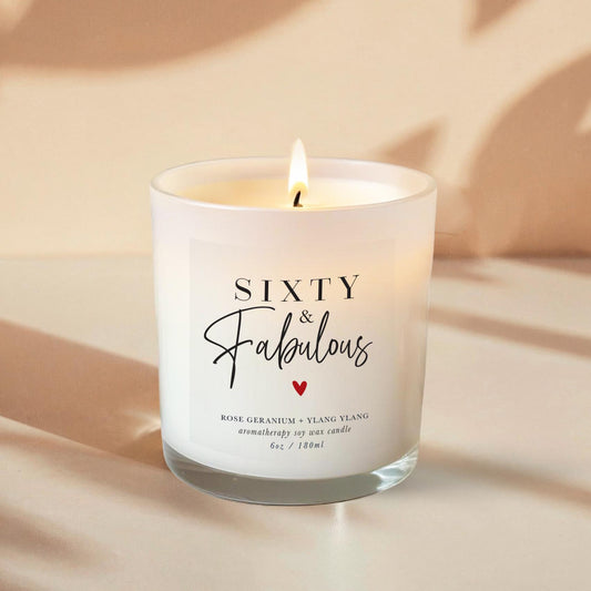 60th Birthday Aromatherapy Candle Gift with a label that says 60 and fabulous and little heart. An all natural candle using only pure essential oils and soy wax