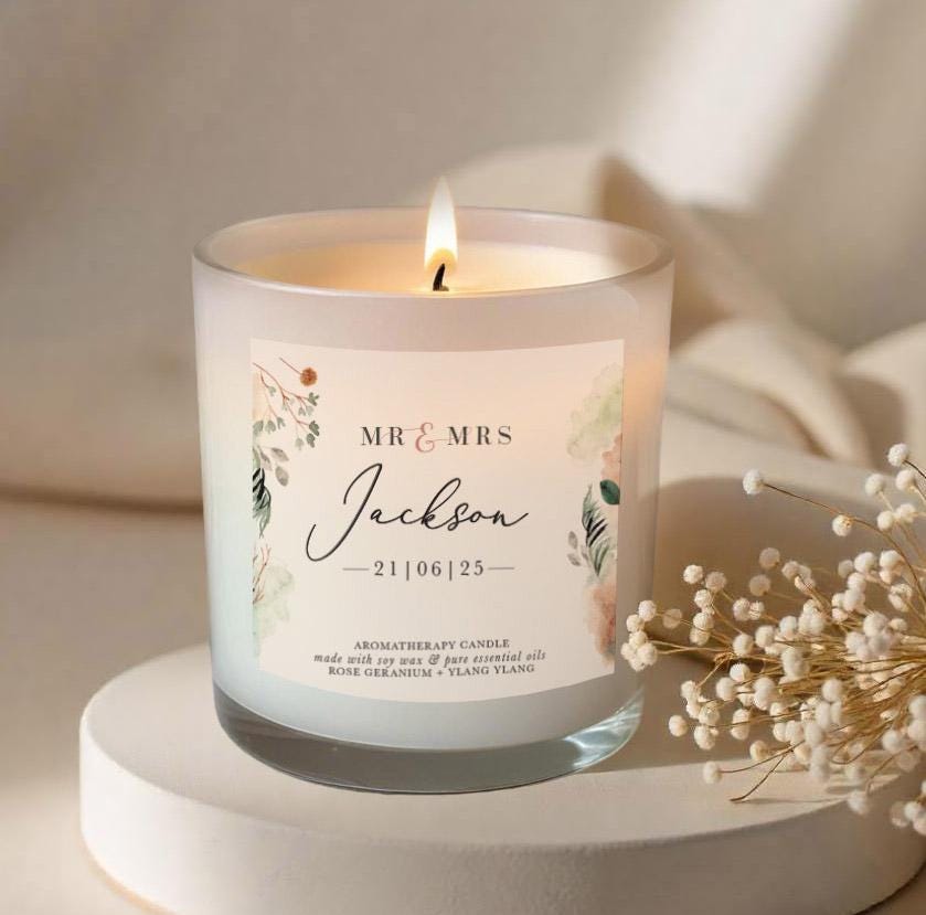 White wedding aromatherapy candle with a personalised floral label with Mr & Mrs and surname and date of wedding.